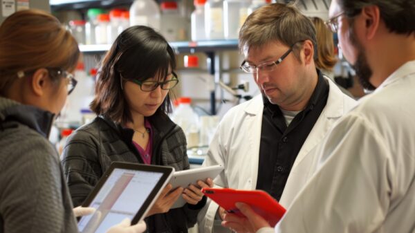 group-researchers-lab-analyzing-data-tablets-one-with-bright-red-phone-case-visible (1)