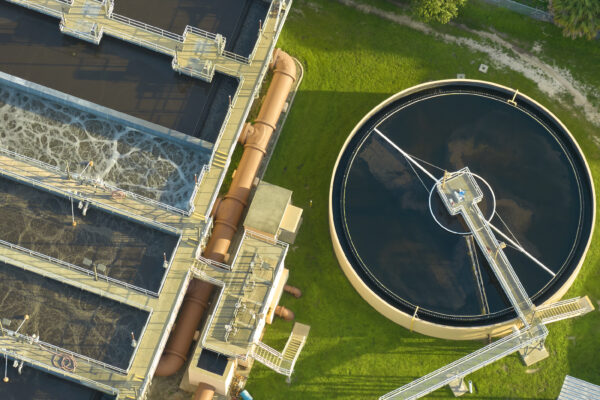 Aerial view of modern water cleaning facility at urban wastewater treatment plant. Purification process of removing undesirable chemicals, suspended solids and gases from contaminated liquid